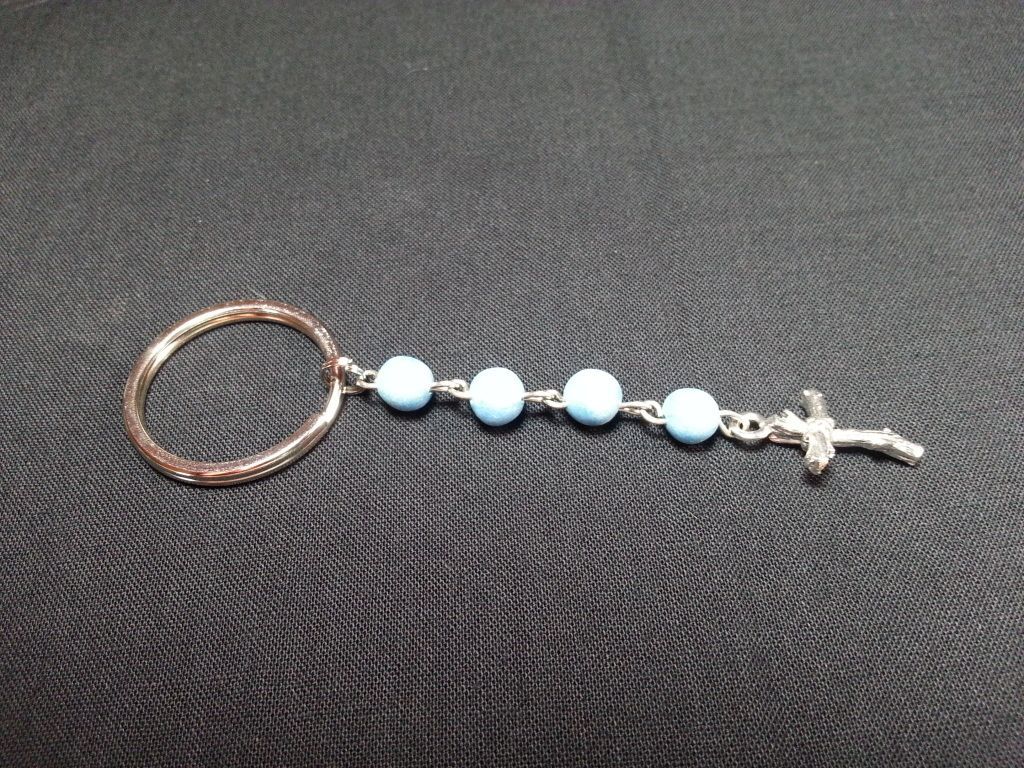 a key chain with blue beads and a cross on it
