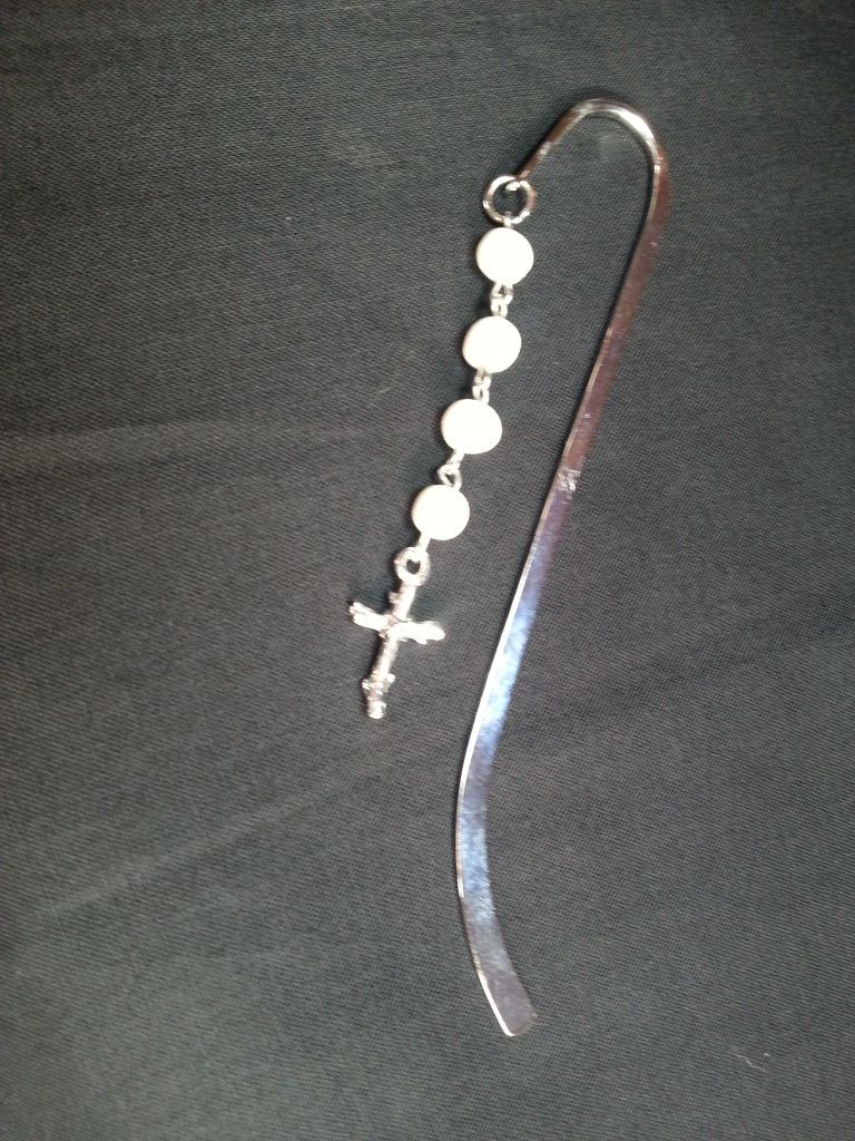 a silver bookmark with a cross on it