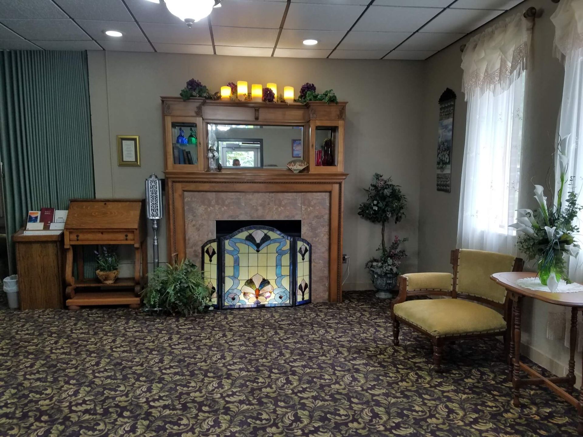 a living room with a stained glass fireplace