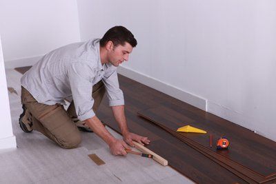 Worker putting wood flooring