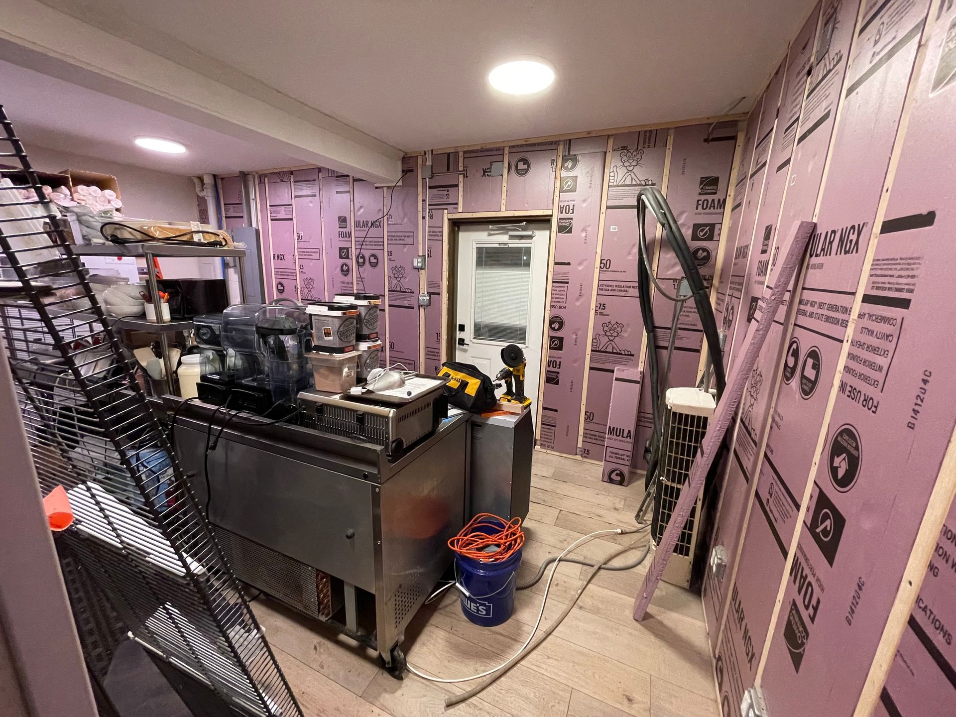 A room with a lot of purple walls and a ladder.