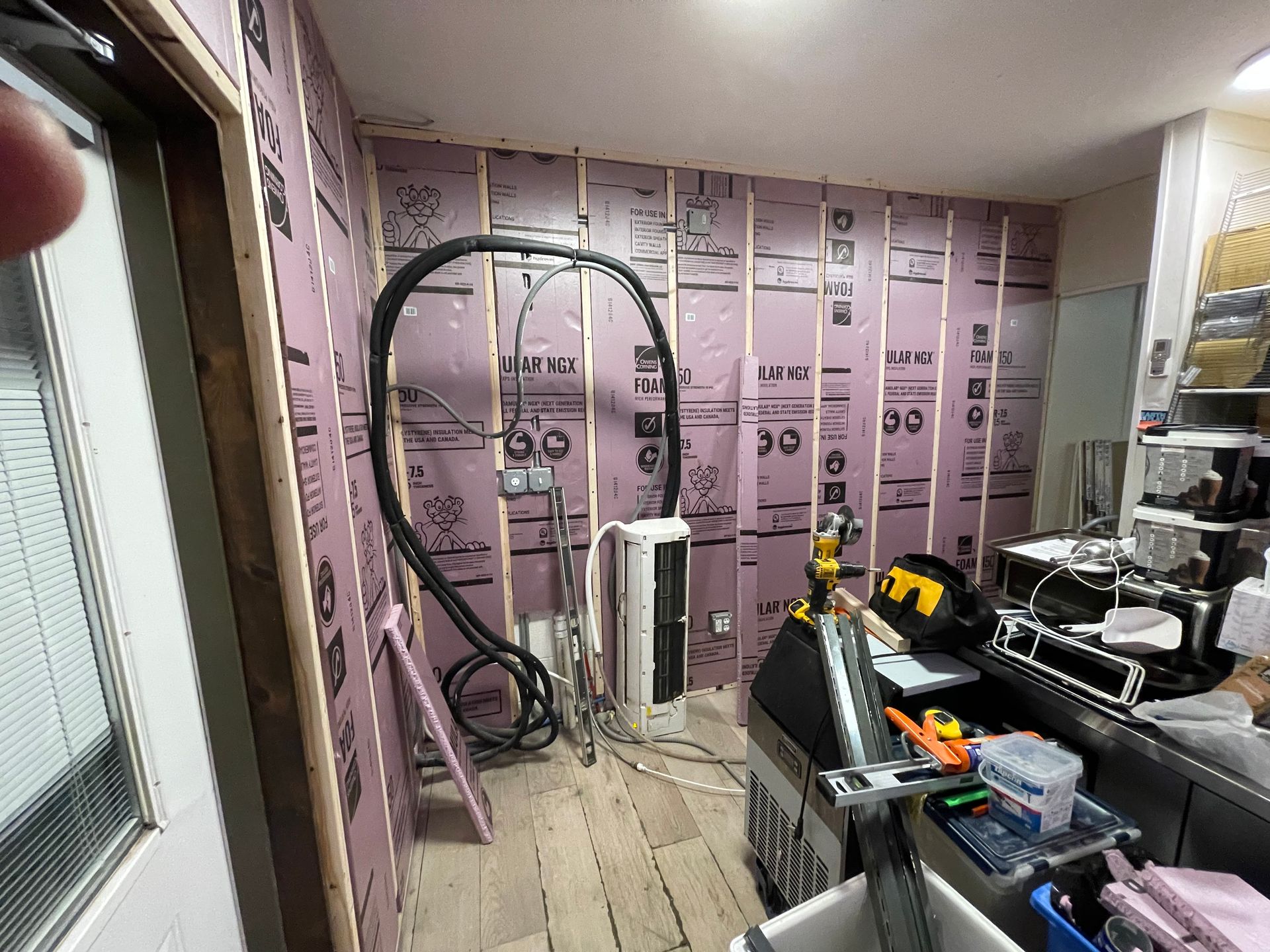 A room with a lot of electrical wires hanging from the walls.