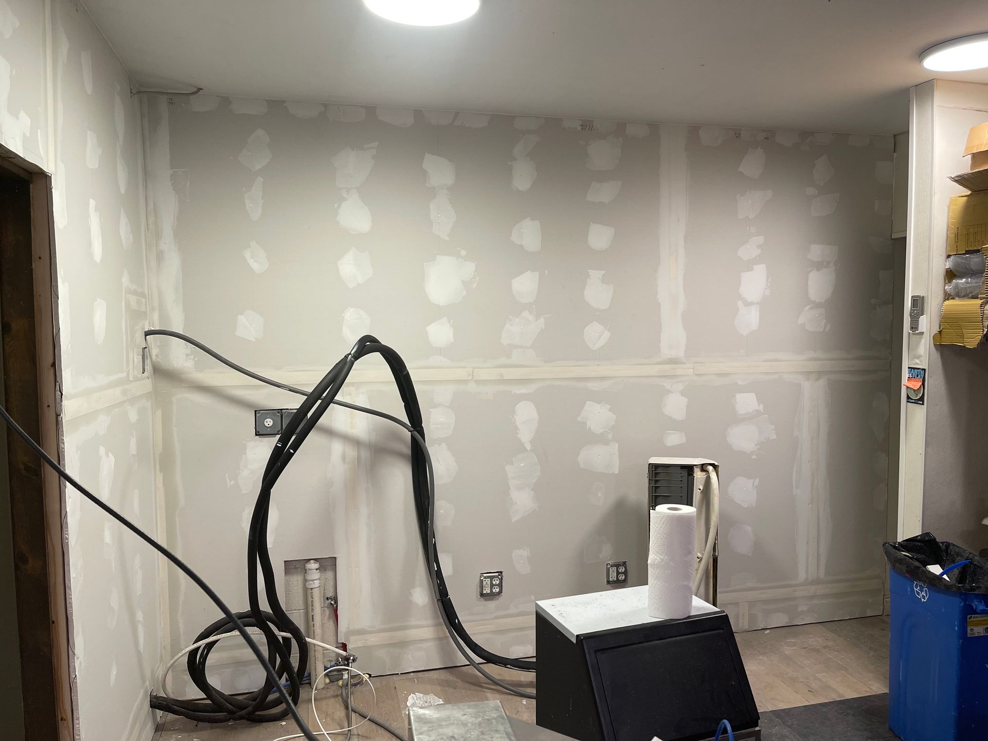 A room with a lot of wires hanging from the ceiling.