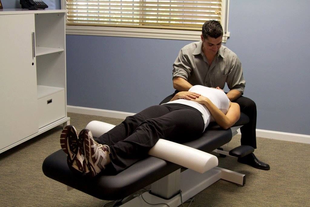 A man is giving a woman a massage on a table