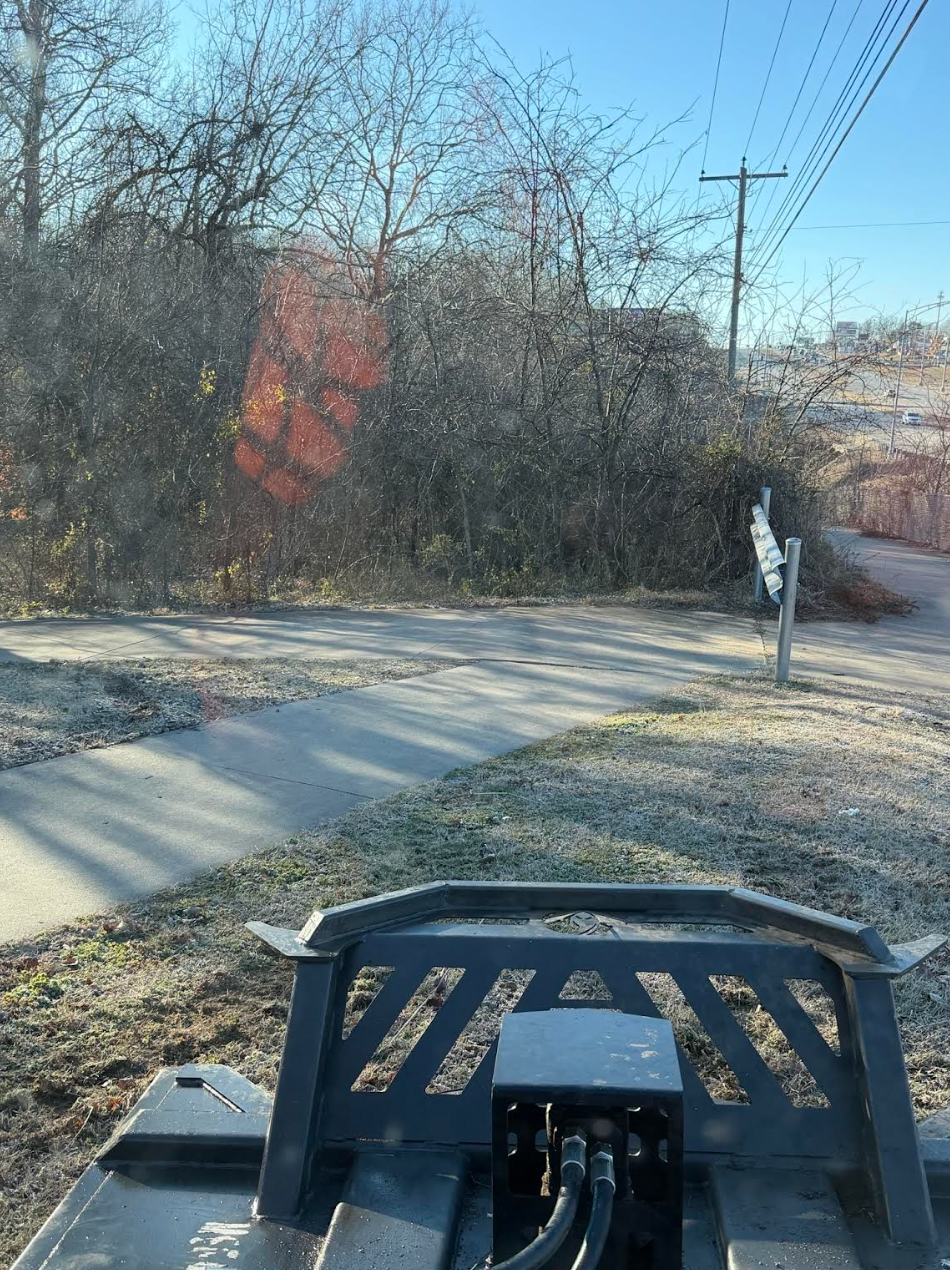 A house at night, lit by a lamp. A grass lawn is in the foreground.