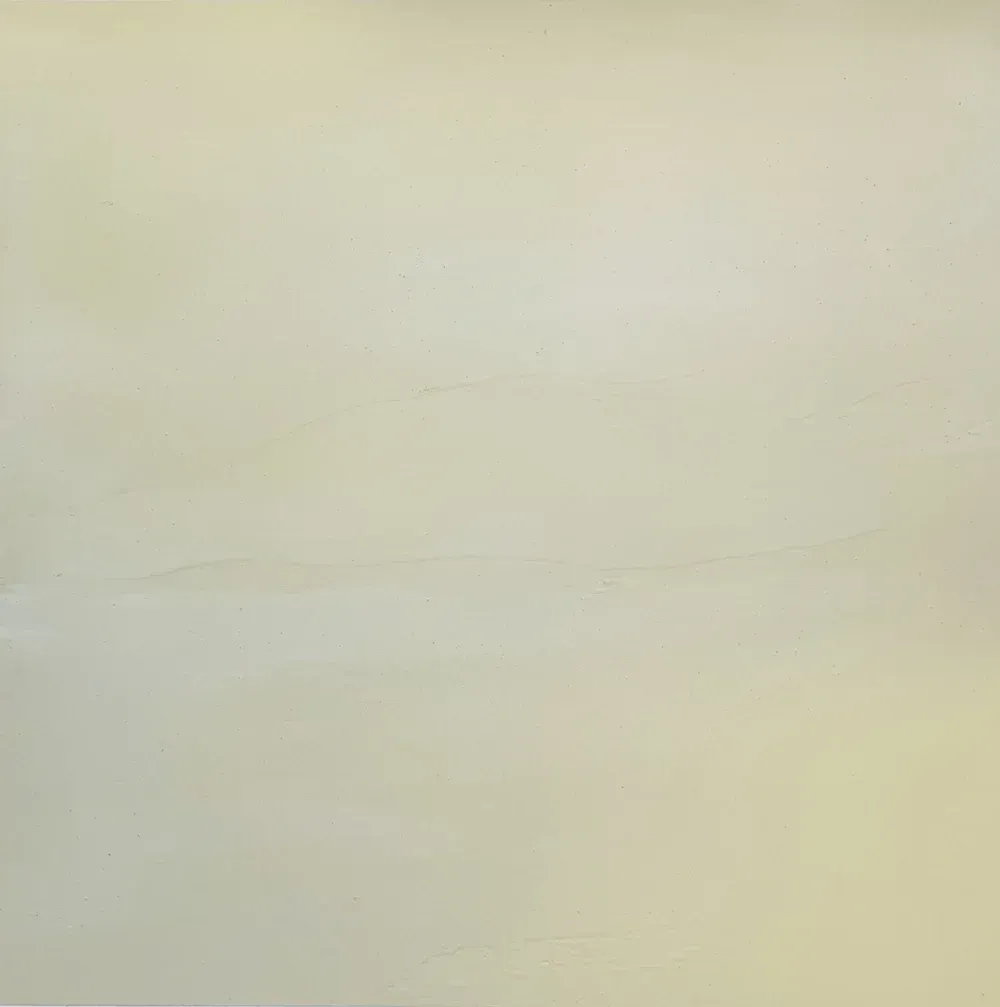 A blank off-white wall with faint horizontal marks and subtle texture.