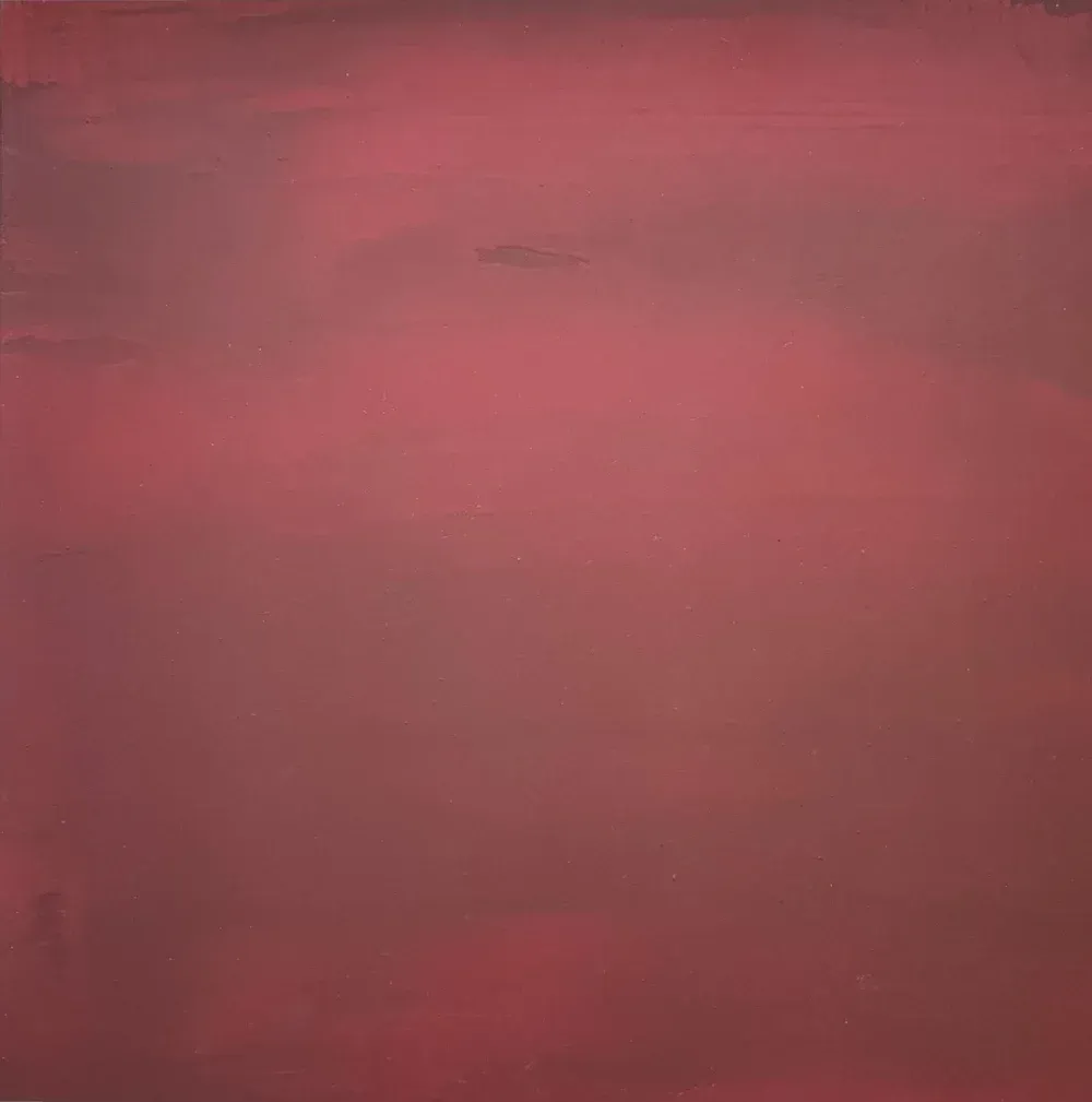 Abstract artwork with a blurred gradient of red and maroon tones.