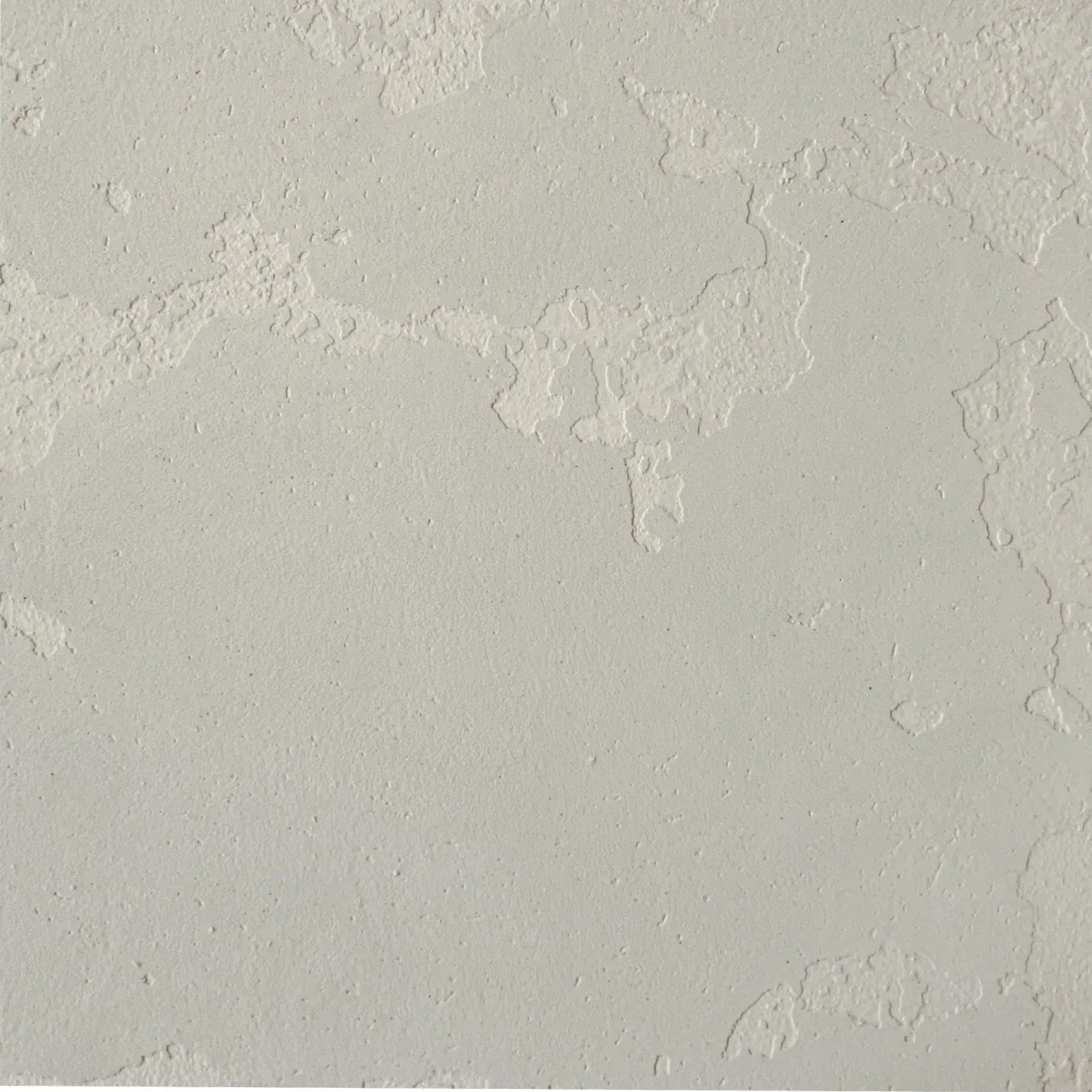 Textured, light gray wall with peeling paint.