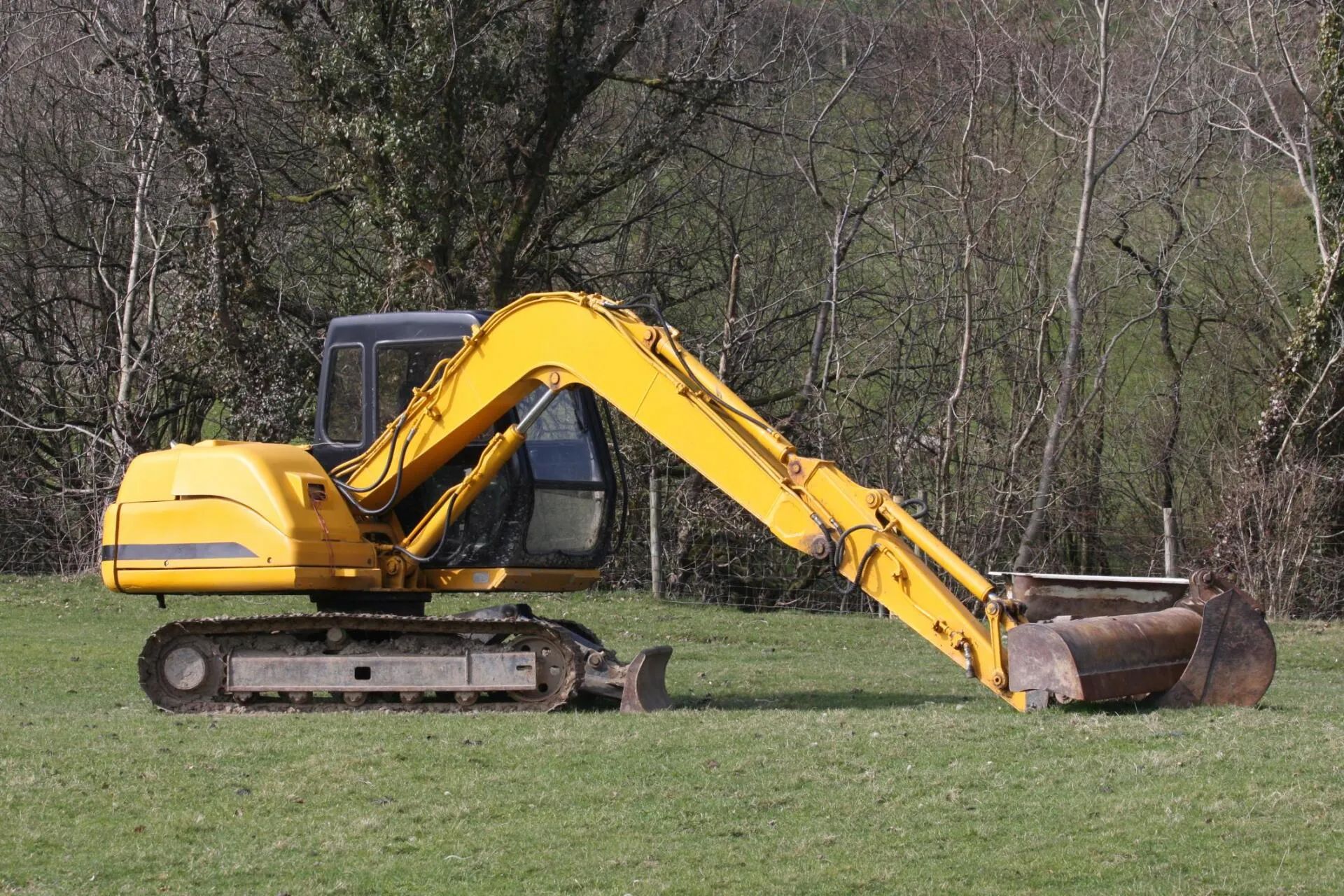 an excavator land clearing a lot