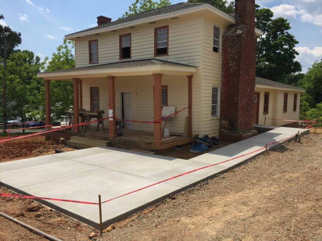 A house with a concrete driveway in front of it