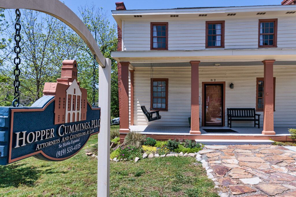 A white house with a blue sign in front of it that says hopper commissary