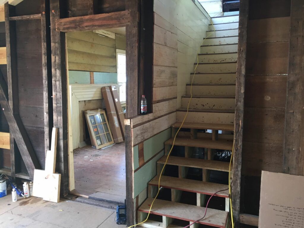 A wooden staircase leading up to the second floor of a house
