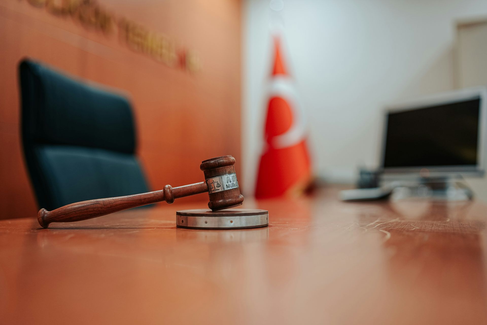 A wooden judge 's gavel is sitting on top of a wooden table.