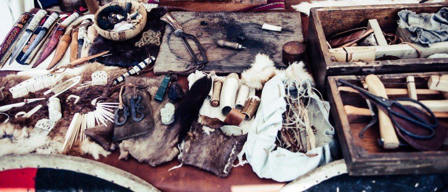 A wooden table topped with a variety of tools.
