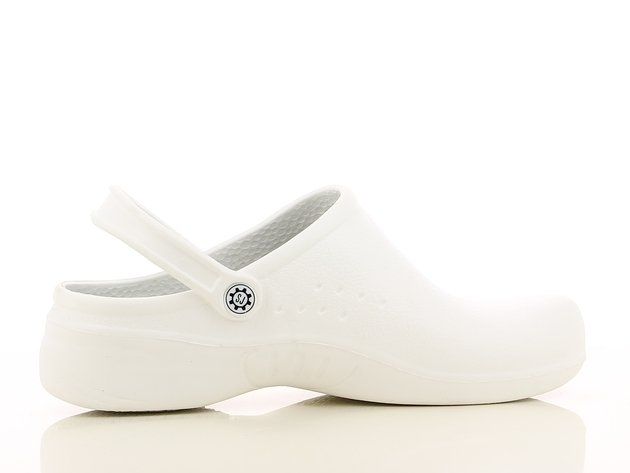 A pair of white clogs on a white surface.