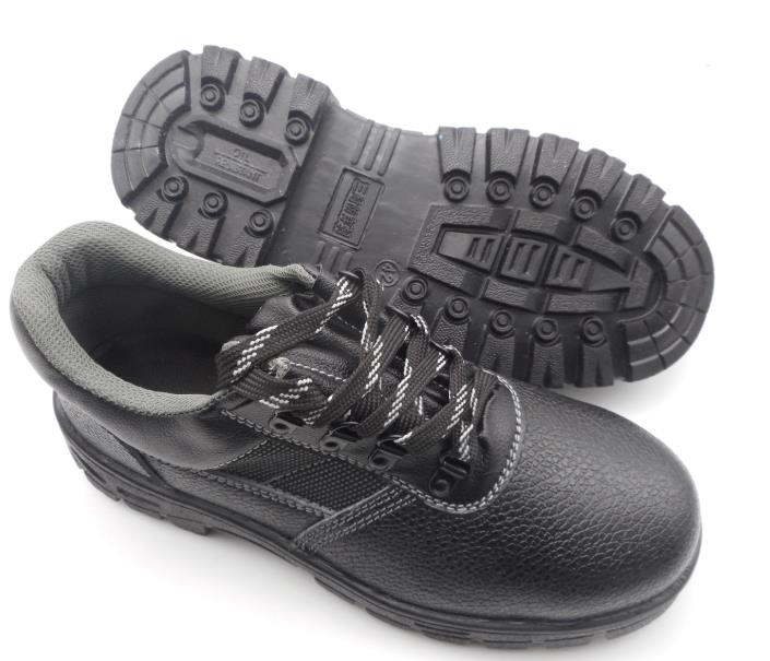 A pair of black safety shoes on a white background