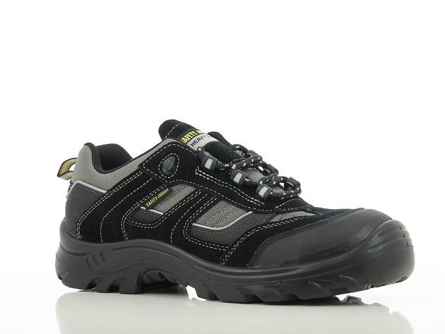 A pair of black and gray safety shoes are sitting on a white surface.