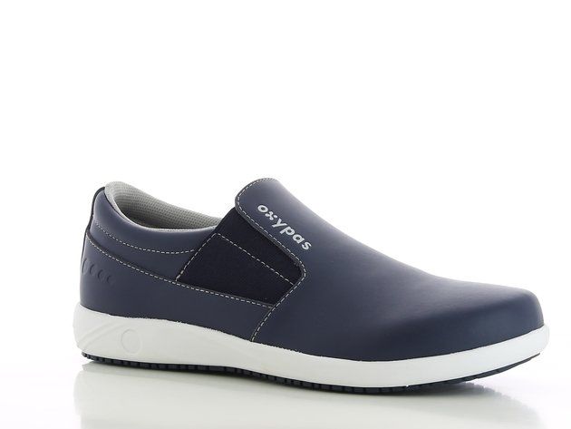 A pair of blue safety shoes with a white sole on a white surface.