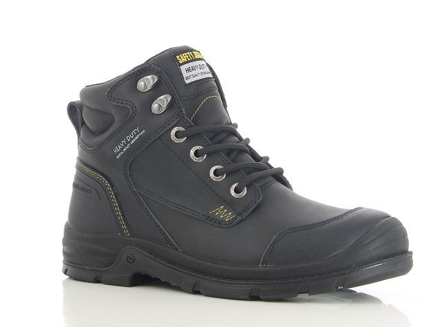 A pair of black safety boots are sitting on a white surface.