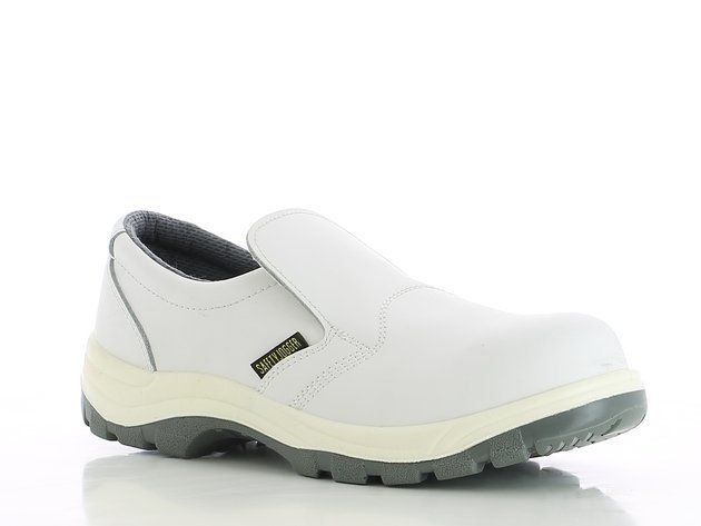 A pair of white safety shoes on a white surface.