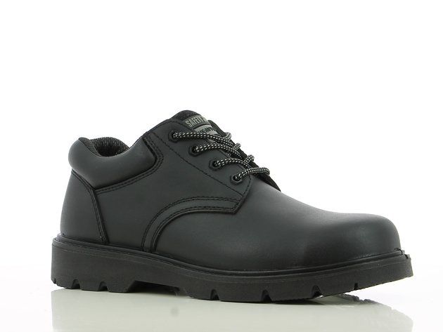 A pair of black safety shoes on a white surface.