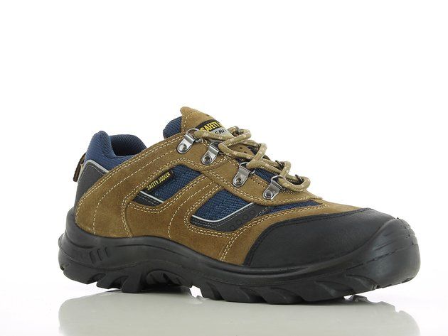 A pair of brown and blue safety shoes are sitting on a white surface.