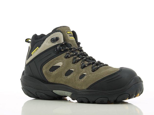 A pair of brown and black hiking boots on a white surface.