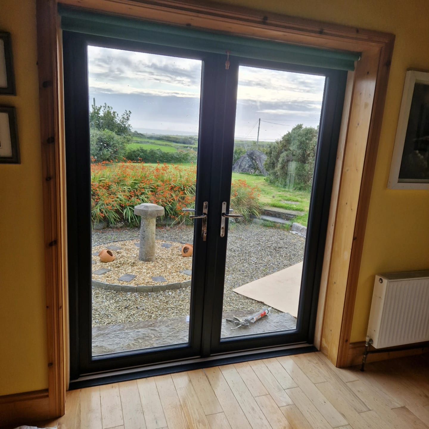A room with a sliding glass door leading to a garden