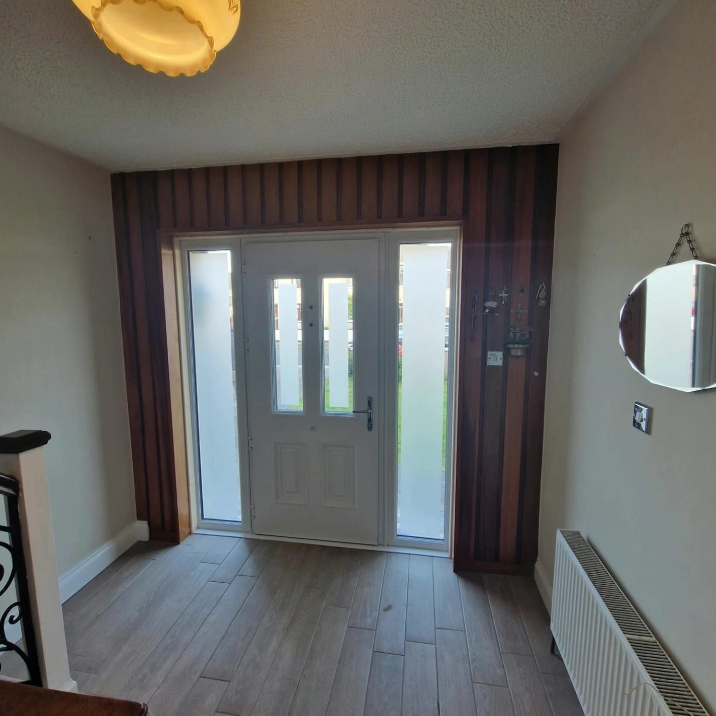 An empty hallway with a door and a mirror