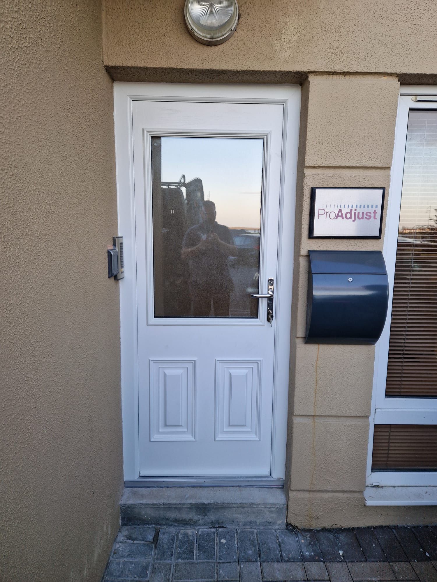A white door with a sign that says adjust on it