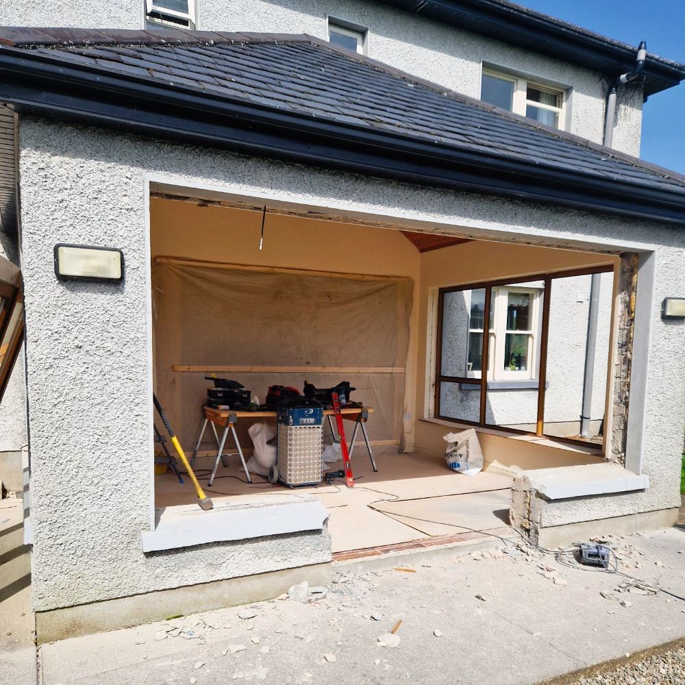 A house that is being remodeled with the garage door open