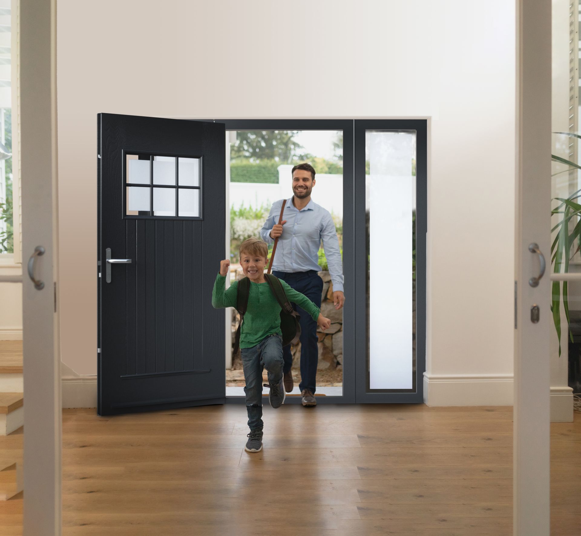 A man and a boy are running out of a doorway.