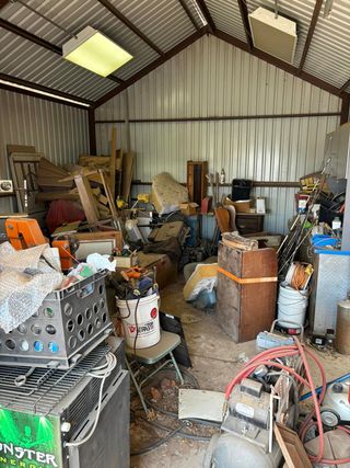 A warehouse filled with lots of junk and tools.