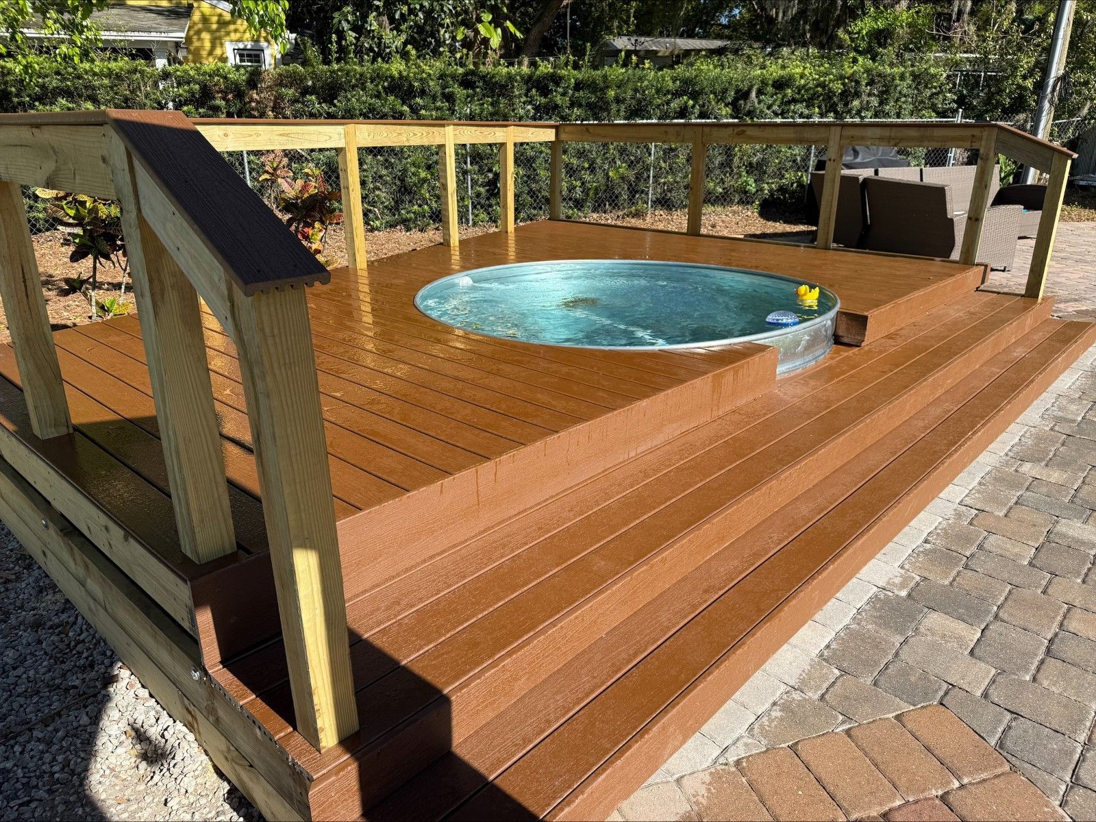 A wooden deck with a hot tub on it
