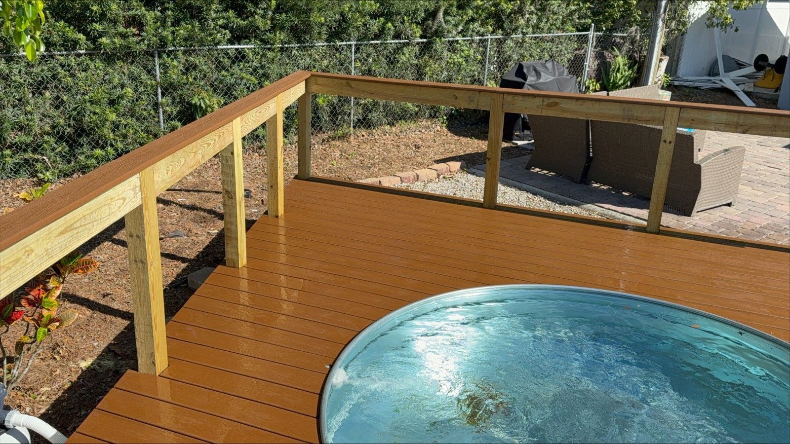 A hot tub is sitting on top of a wooden deck.