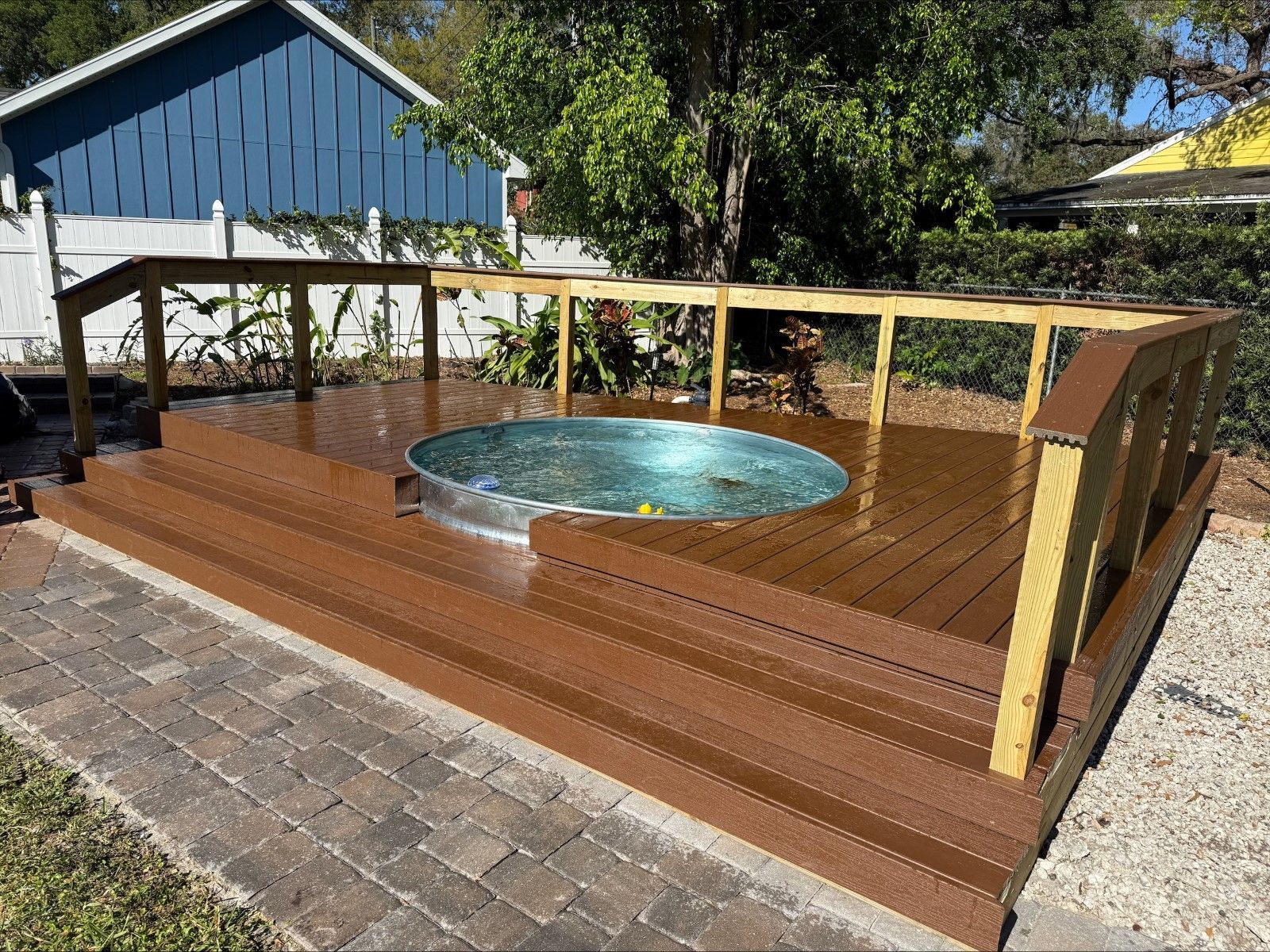 A hot tub is sitting on top of a wooden deck.