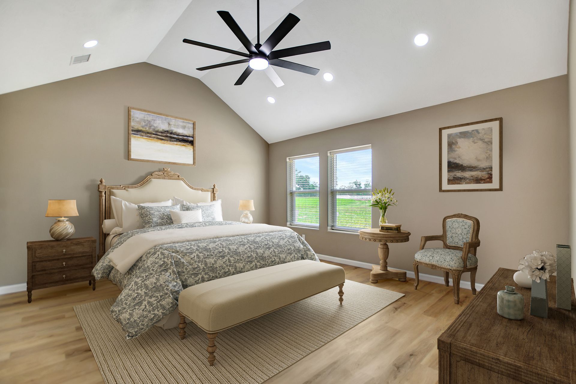 Bedroom with vaulted ceiling, beige walls, wooden furniture, bed, chair, and ceiling fan.