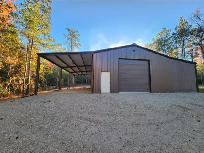 A large brown metal building with a garage door