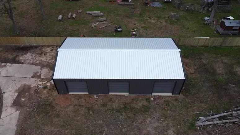 An aerial view of a garage with a white roof.