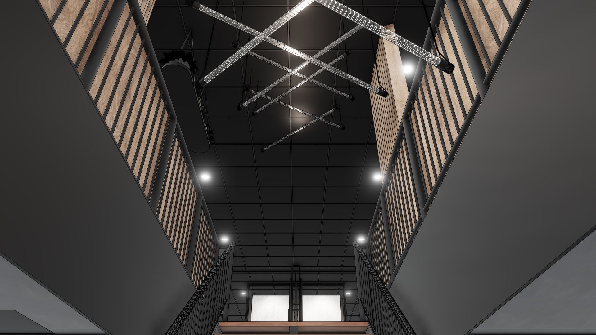 Modern trappenhuis met donkere muren, metalen leuningen en felle plafondlampen, gezien vanaf beneden.