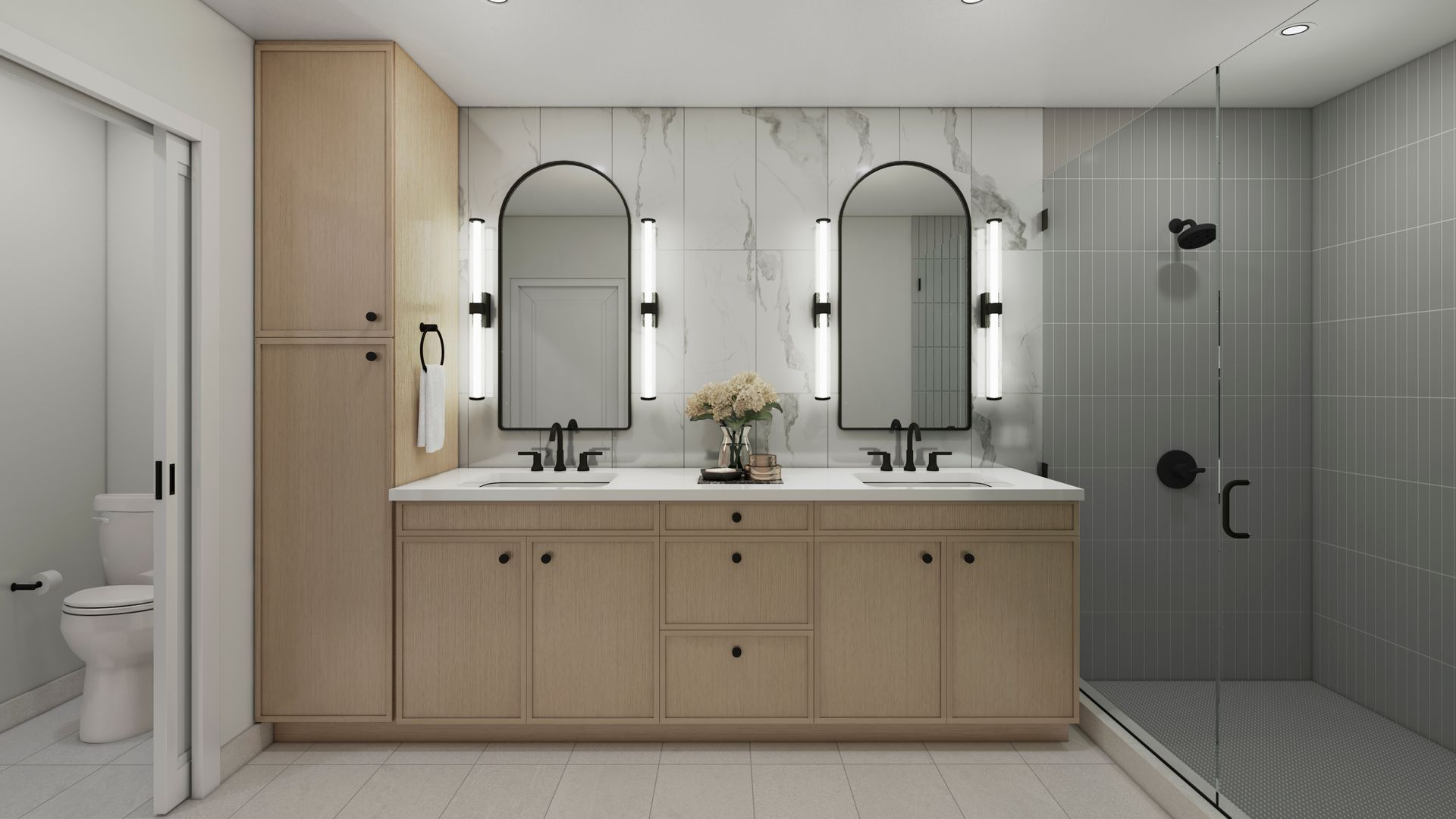 Modern bathroom with double vanity, arched mirrors, and gray tiled shower.