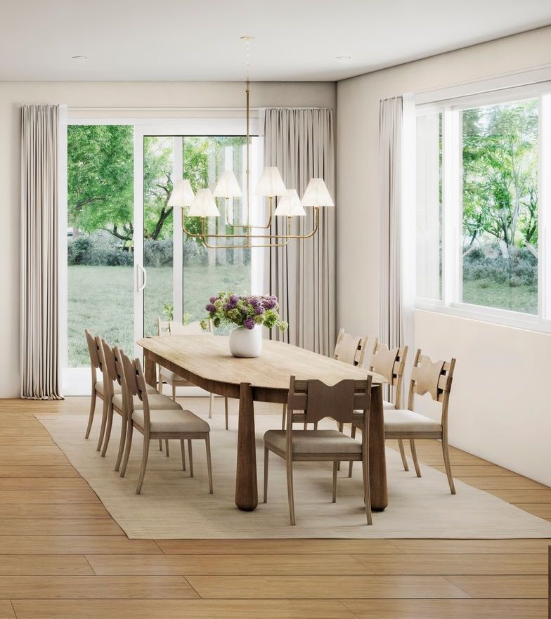 Dining room with long wooden table, chairs, large windows, and a chandelier.