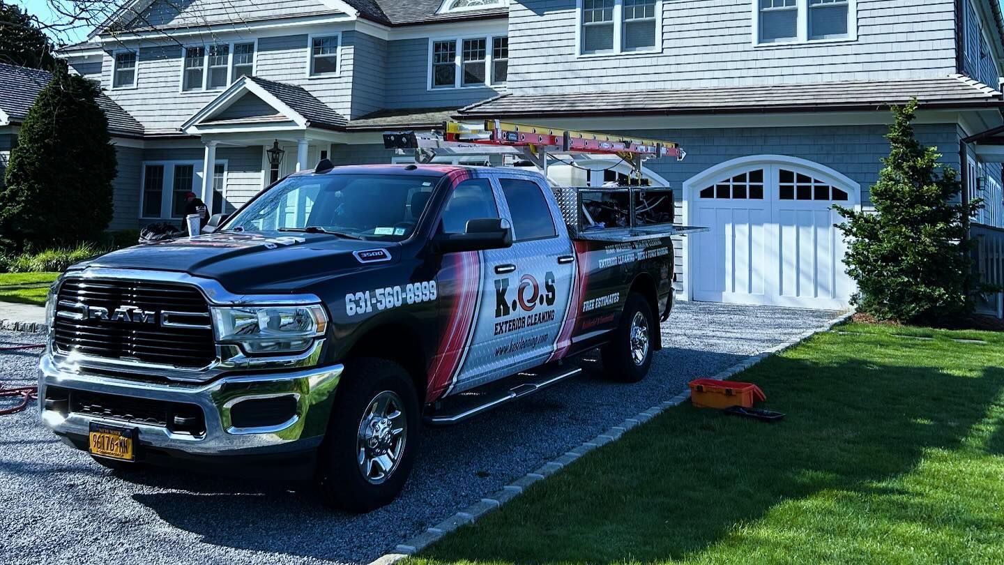Technician power washing a patio to prep a Suffolk County home for summer
