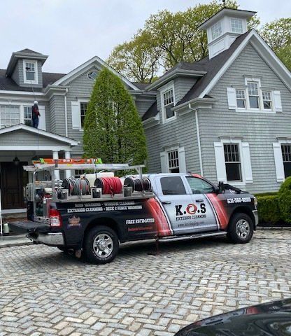 a k.o.s truck is parked in front of a house