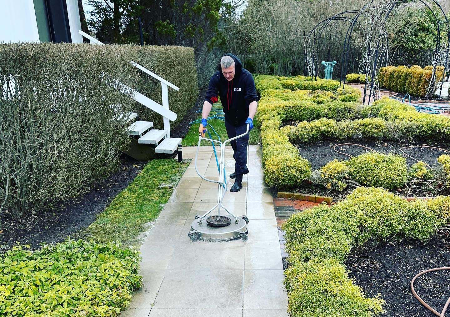 KOS is pressure washing a walkway at a home on Long Island 