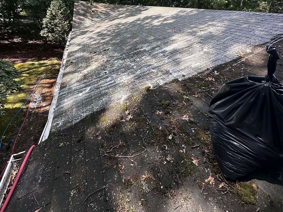 K.O.S. Cleaning team removing roof stains on a Long Island home