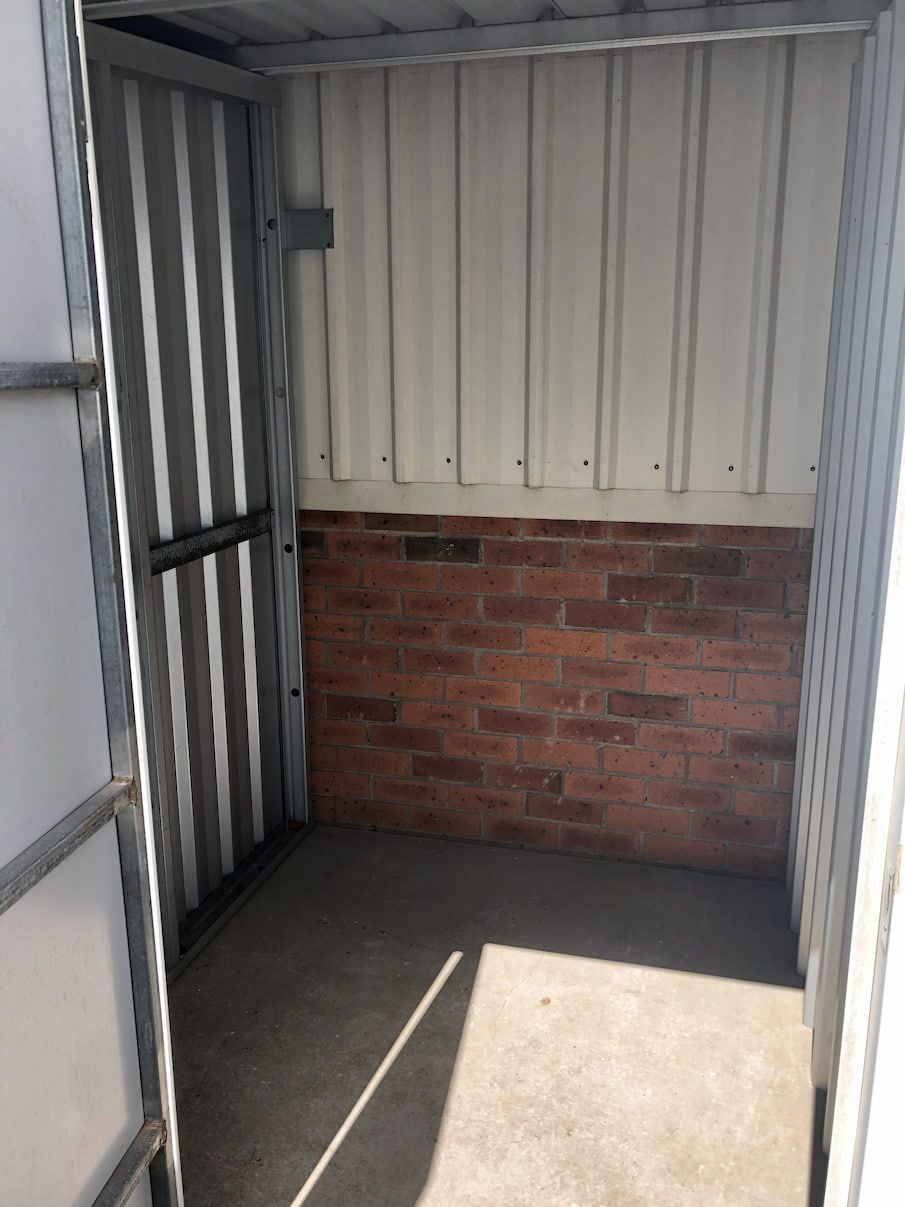 A Small Room With A Brick Wall And A Door  — Acacia Mini Storage in Port Macquarie, NSW