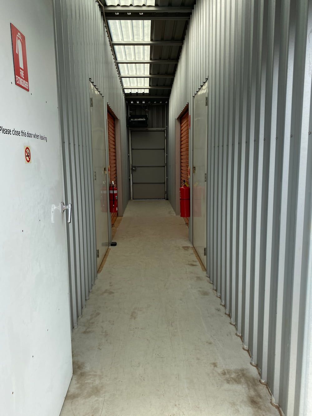 A Long Hallway With A Fire Extinguisher On The Wall  — Acacia Mini Storage in Port Macquarie, NSW