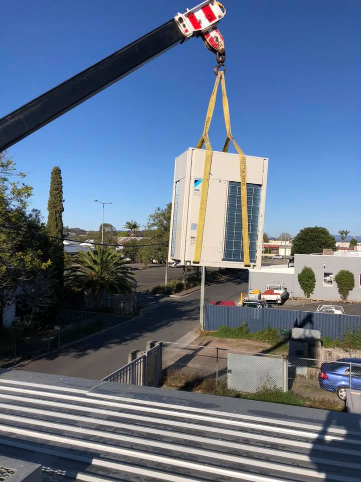 Crane Lifting Air Conditioning Unit — Refrigeration & Air Conditioning in Kempsey, NSW