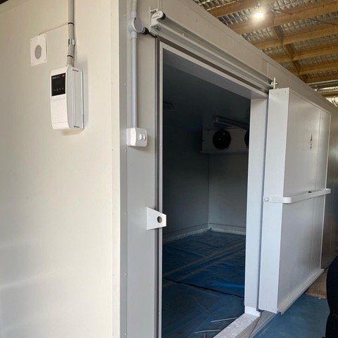 Sliding freezer room door open for inspection